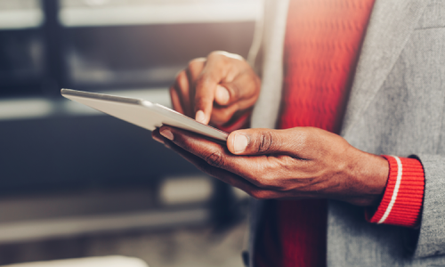 Person reviewing an Intune implementation checklist on a tablet device in a modern office setting.