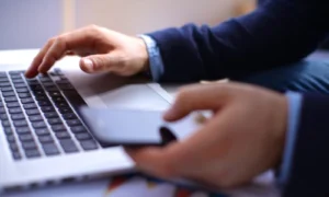 A person reviewing Microsoft OneDrive's update policy on their laptop.