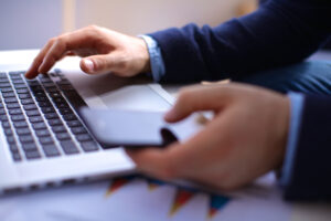 A person reviewing Microsoft OneDrive's update policy on their laptop.