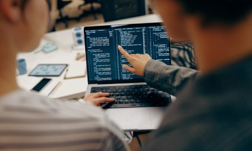 A developer in front of a computer migrating data to Microsoft Intune.