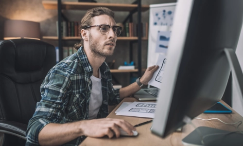 An IT expert working on a data migration project on his computer.